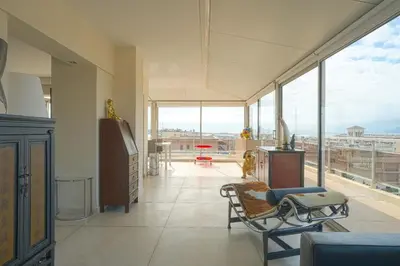 a large living room with a view of a city at Villa sur le toit - Vue mer exceptionnelle in Cannes