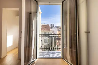 a room with a window with a view of a balcony at 06AG - Bel appartement proche Palais des Festivals in Cannes