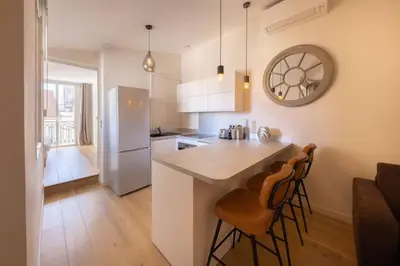 a kitchen with a counter and two bar stools at 06AG - Bel appartement proche Palais des Festivals in Cannes