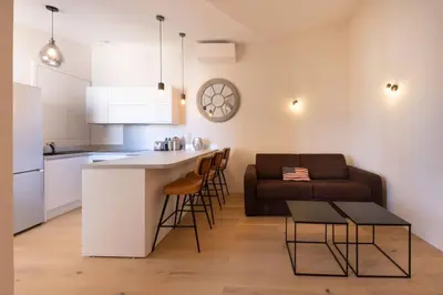 a kitchen and living room with a couch and a table at 06AG - Bel appartement proche Palais des Festivals in Cannes