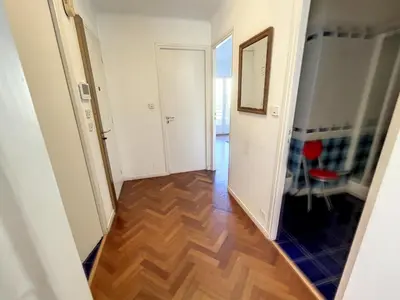 a hallway with a hard wood floor and white walls at 1 bedroom Latour Maubourg Cannes Riviera 245 in Cannes