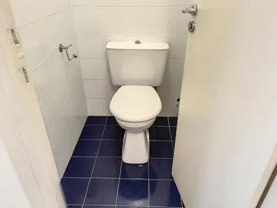 a bathroom with a toilet and a blue tile floor at 1 bedroom Latour Maubourg Cannes Riviera 245 in Cannes