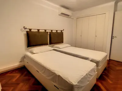two beds in a small room with wooden floors at 1 bedroom Latour Maubourg Cannes Riviera 245 in Cannes