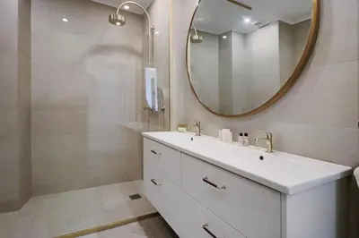 a bathroom with a white sink and a mirror at LE SUQUET - Bright renovated and spacious apartment in Cannes