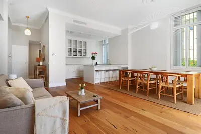 a living room and kitchen with a table and a couch at LE SUQUET - Bright renovated and spacious apartment in Cannes