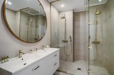 a bathroom with a shower and a sink and a mirror at LE SUQUET - Bright renovated and spacious apartment in Cannes