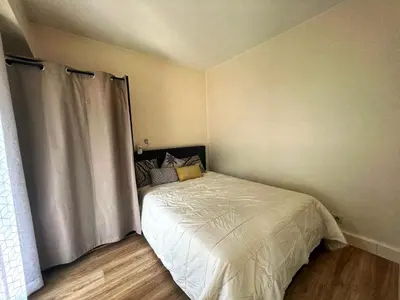 a small bedroom with a bed with a white comforter at V Park by Welcome to Cannes in Cannes