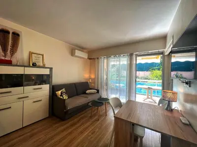a living room with a couch and a table at V Park by Welcome to Cannes in Cannes