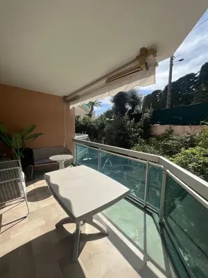 a balcony with a table and a glass railing at V Park by Welcome to Cannes in Cannes