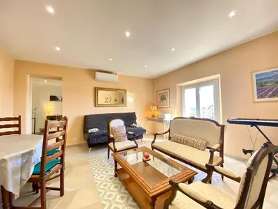 a living room with a couch and a table at Palais Azur By SCLS Locations in Cannes