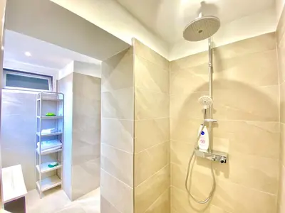 a bathroom with a shower with a shower head at Palais Azur By SCLS Locations in Cannes