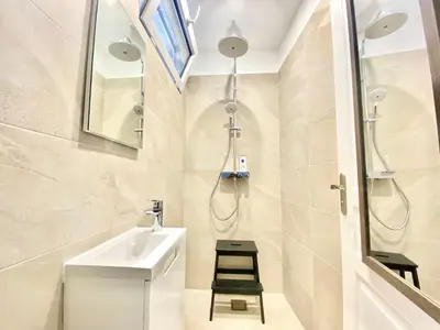 a bathroom with a sink and a shower at Palais Azur By SCLS Locations in Cannes