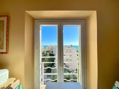 a large window with a view of a building at Palais Azur By SCLS Locations in Cannes