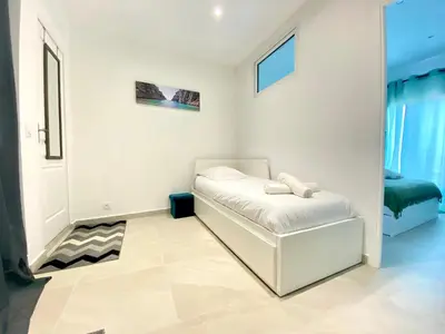 a white room with a bed in the corner at Palais Azur By SCLS Locations in Cannes
