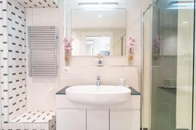 a white bathroom with a sink and a mirror at Cannes Rue d'Antibes Premium 2 BDR 2 baths Exclusive Olam Properties in Cannes