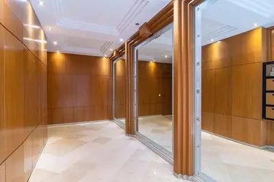 a hallway with wooden walls and a large mirror at Cannes Rue d'Antibes Premium 2 BDR 2 baths Exclusive Olam Properties in Cannes