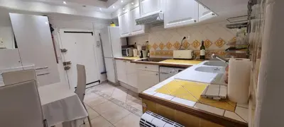a kitchen with white cabinets and a sink at Cannes Meynadier: Superbe appartement trois pièces in Cannes