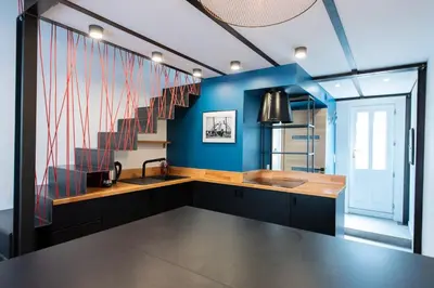 a kitchen with a sink and a blue wall at LE CHANCEUX fabuleux duplex en design, pour loisir en couple ou congrès in Cannes