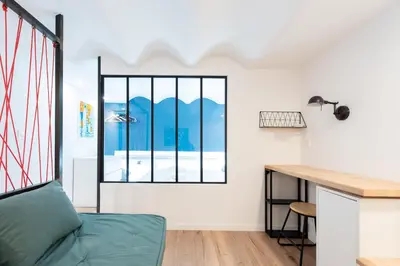 a room with a desk and a window at LE CHANCEUX fabuleux duplex en design, pour loisir en couple ou congrès in Cannes