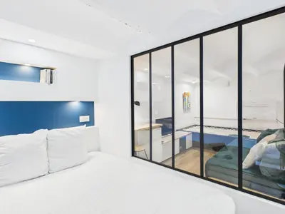 a bedroom with a large glass window and a bed at LE CHANCEUX fabuleux duplex en design, pour loisir en couple ou congrès in Cannes