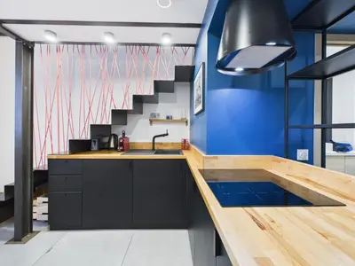 a kitchen with a sink and a blue wall at LE CHANCEUX fabuleux duplex en design, pour loisir en couple ou congrès in Cannes