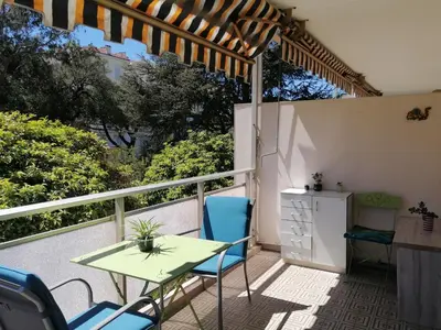 a patio with a table and chairs on a balcony at Résidence Côte d'Azur Cannes in Cannes