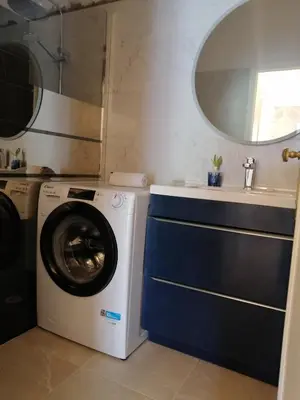 a bathroom with a washing machine and a sink at Résidence Côte d'Azur Cannes in Cannes