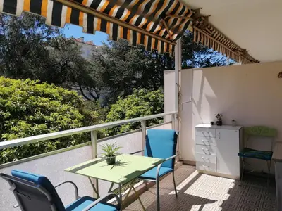 a patio with a table and chairs on a balcony at Résidence Côte d'Azur Cannes in Cannes