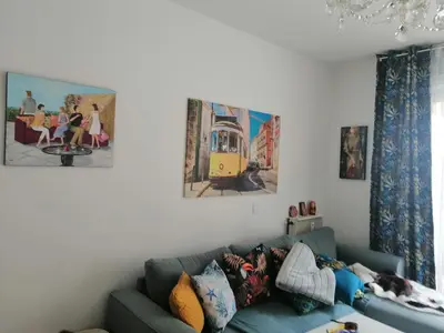 a living room with a blue couch with pillows at Résidence Côte d'Azur Cannes in Cannes