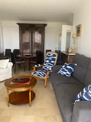 a living room with a couch and a table at Appartement vue sur mer, proche Croisette in Cannes