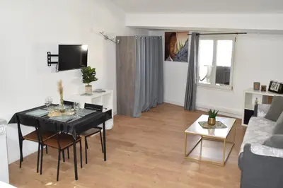 a living room with a table and a couch at Grand studio-Mezzanine-Centre Cannes in Cannes