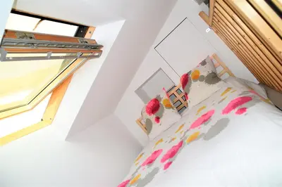 a bedroom with a bed and a window at Grand studio-Mezzanine-Centre Cannes in Cannes