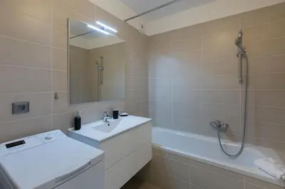 a bathroom with a sink and a shower and a tub at 2 pièces avec clim, terrasse, piscine, 100m plage in Cannes