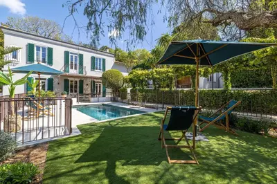 a yard with a pool and an umbrella and chairs at Luxurious Villa with heated pool 5BR-10p - Cannes in Cannes