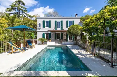 a swimming pool in front of a house at Luxurious Villa with heated pool 5BR-10p - Cannes in Cannes