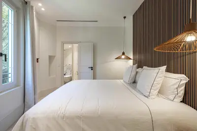 a bedroom with a large bed with white pillows at Luxurious Villa with heated pool 5BR-10p - Cannes in Cannes