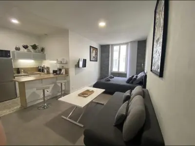 a living room with a couch and a table at PACA Properties 41H2 - Studio cosy in Cannes