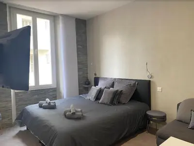 a bedroom with a bed with two stuffed animals on it at PACA Properties 41H2 - Studio cosy in Cannes