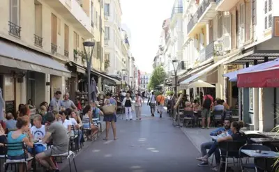 a crowd of people sitting in chairs on a city street at PACA Properties 41H2 - Studio cosy in Cannes