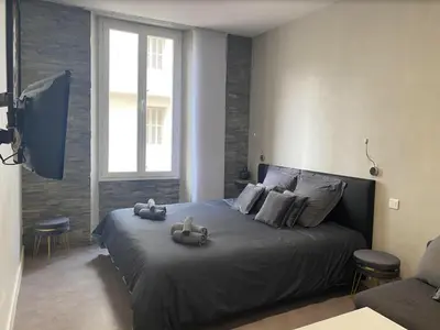 a bedroom with a bed with two stuffed animals on it at PACA Properties 41H2 - Studio cosy in Cannes