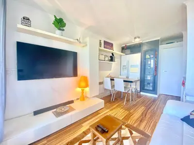 a living room with a large flat screen tv on a wall at Le Delacroix 2 By SCLS Locations in Cannes