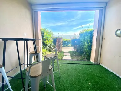 a patio with a view of a yard with green grass at Le Delacroix 2 By SCLS Locations in Cannes