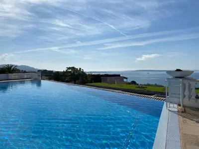 a large swimming pool with a view of the ocean at Le Delacroix 2 By SCLS Locations in Cannes