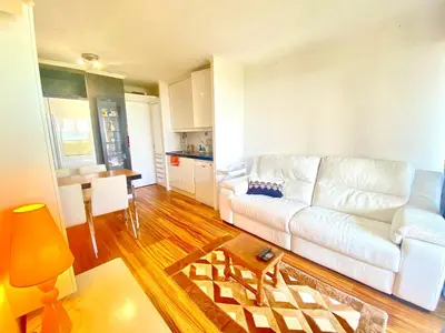 a living room with a white couch and a table at Le Delacroix 2 By SCLS Locations in Cannes