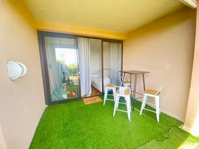 a room with a table and chairs and green grass at Le Delacroix 2 By SCLS Locations in Cannes