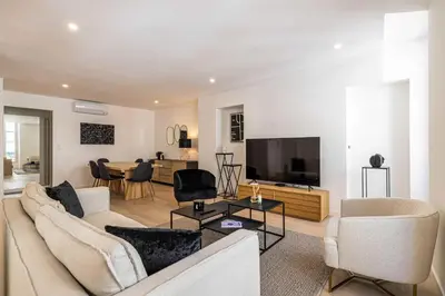 a living room with a couch and a tv at Superb 90m2 apartment in the heart of Cannes in Cannes