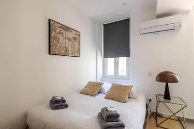 a bedroom with a bed with towels on it at Superb 90m2 apartment in the heart of Cannes in Cannes