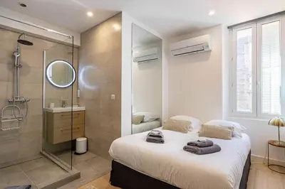 a bedroom with a large bed and a shower at Superb 90m2 apartment in the heart of Cannes in Cannes