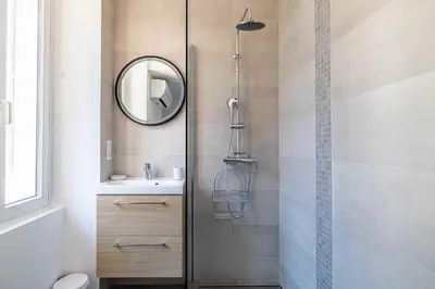 a bathroom with a shower and a sink and a mirror at Superb 90m2 apartment in the heart of Cannes in Cannes