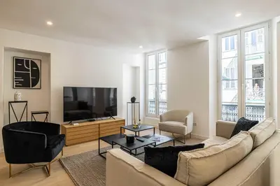 a living room with a couch and a flat screen tv at Superb 90m2 apartment in the heart of Cannes in Cannes